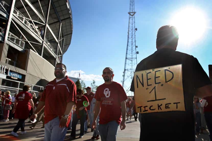 In this file photo, fans look for tickets to buy before the Oklahoma University Sooners vs....