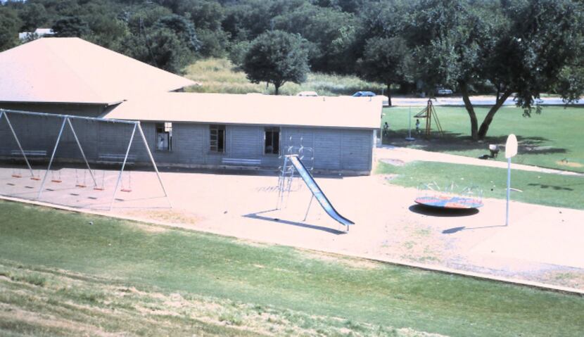 A 1970s photo shows the recreation center and playground equipment at Oak Cliff Park, which...