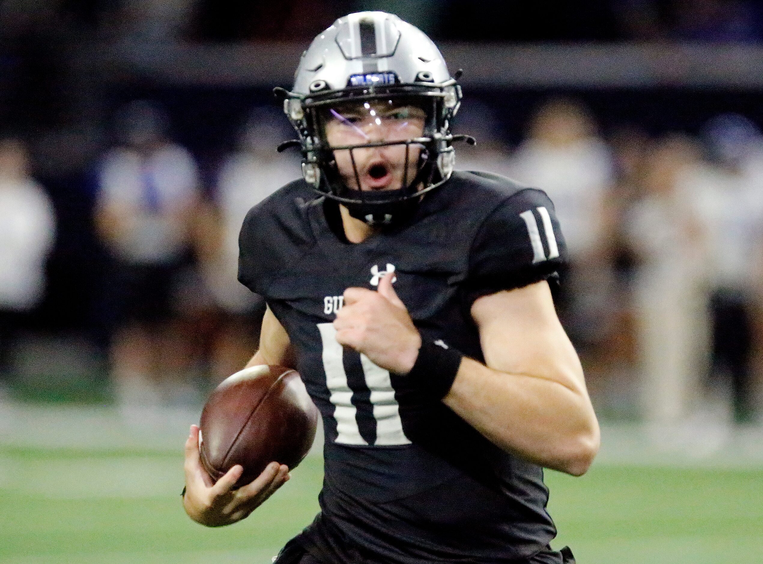 Guyer High School quarterback Jackson Arnold (11) runs the ball during the first half as...