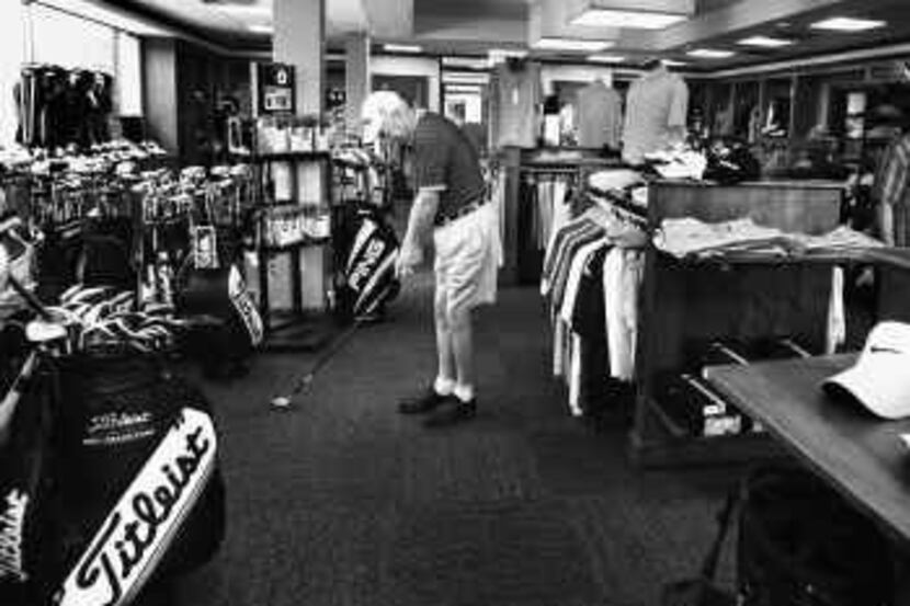  Hardy Tadlock tries out some clubs in the pro shop at Brookhaven Country Club in Farmers...