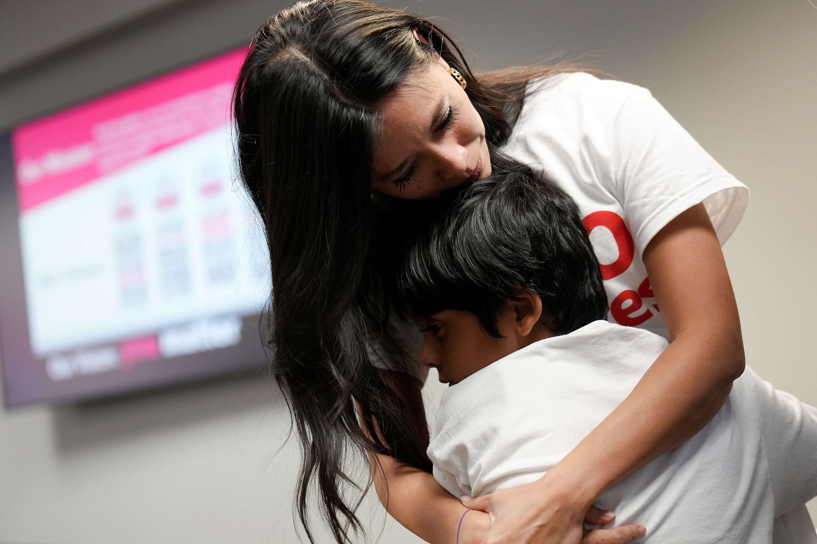 Parent Julie Waters consoles a Pinkerton Elementary School student after a vote to close the...