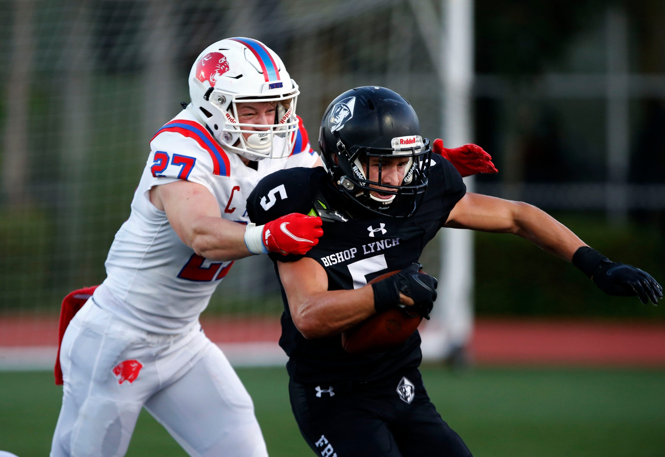 Parish Episcopal defender Henry Partridge (27) tackles Bishop Lynch’s Cort Doyle (5) for a...