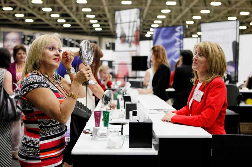  Awilda Arbelo, of Puerto Rico, tries Mary Kay products from the "Midnight Jewels...