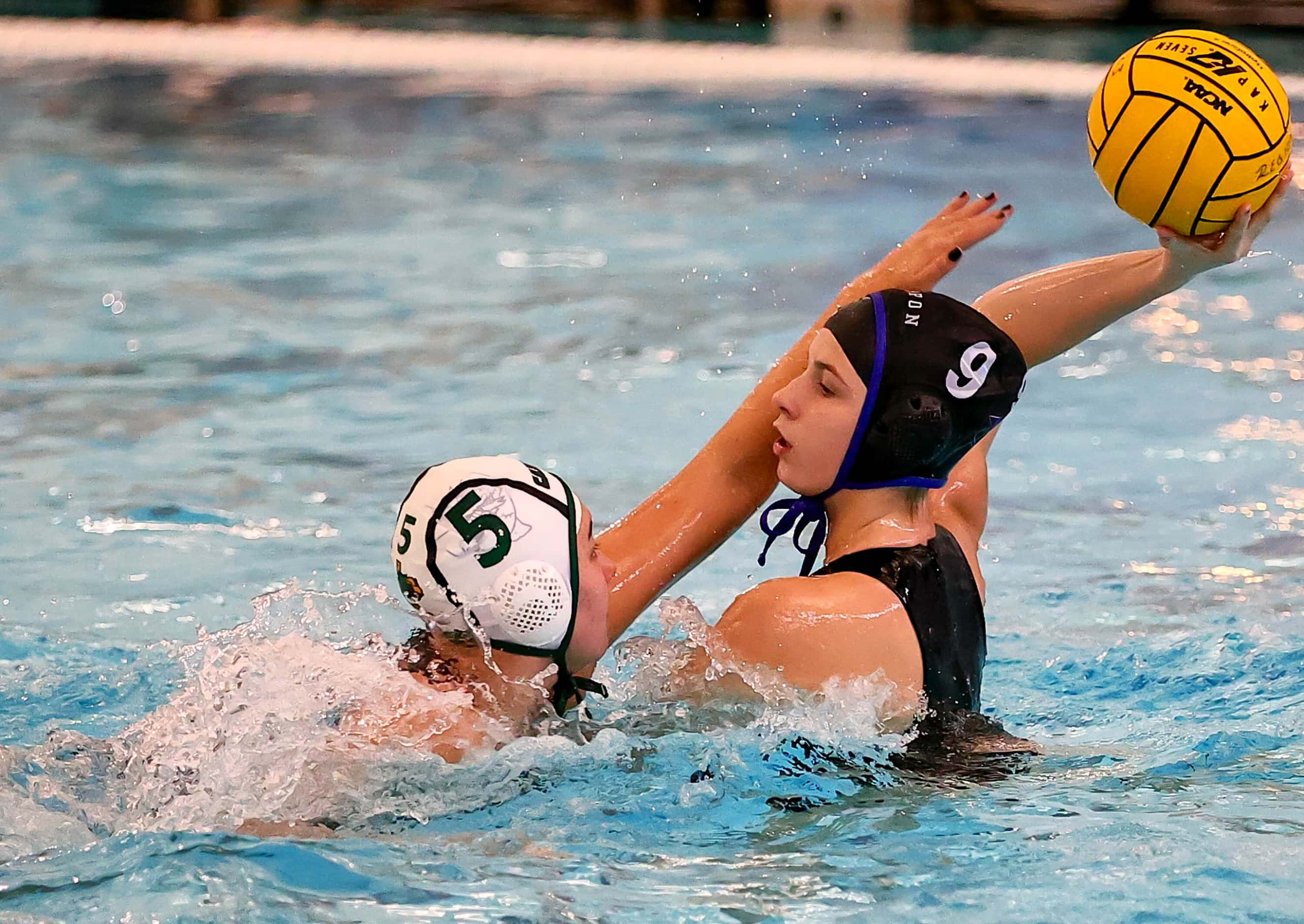 Hebron's Mia Slaughter (9) looks to make a pass against Southlake Carroll's Chloe Criswell...