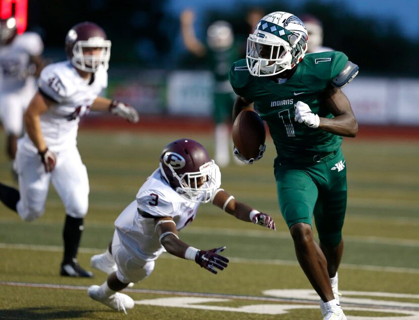 Waxahachie receiver Jalen Reagor runs the ball past Ennis cornerback Ike Walker in the first...