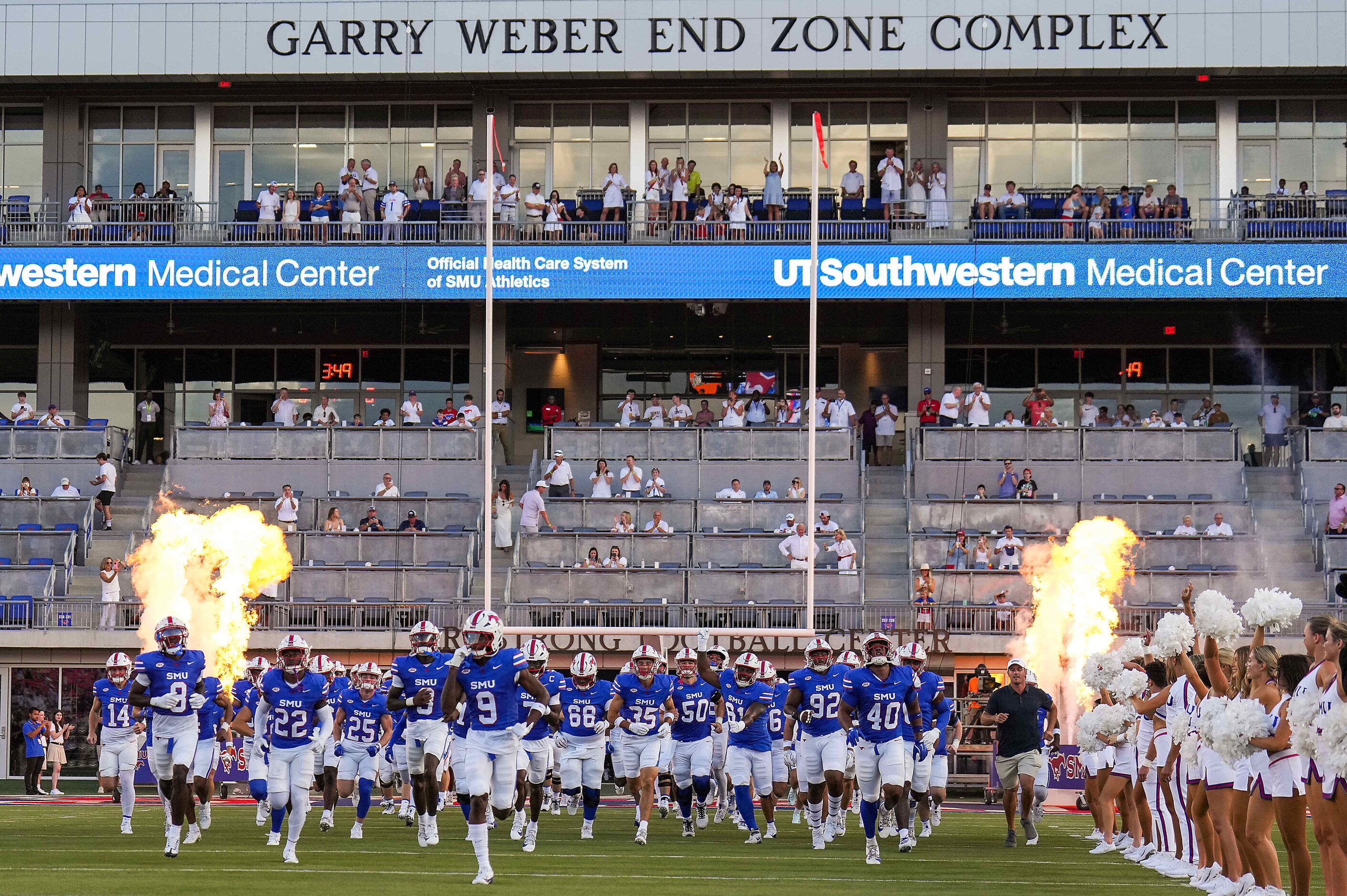 SMU players race from the the brand new Garry Weber End Zone Complex at Gerald J. Ford...