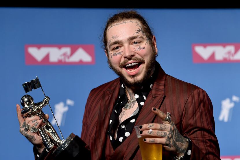 Post Malone poses with the award for song of the year for "Rockstar" in the press room at...