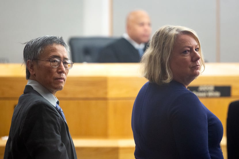 Former doctor George Guo stands with his defense lawyers during his capital murder trial...