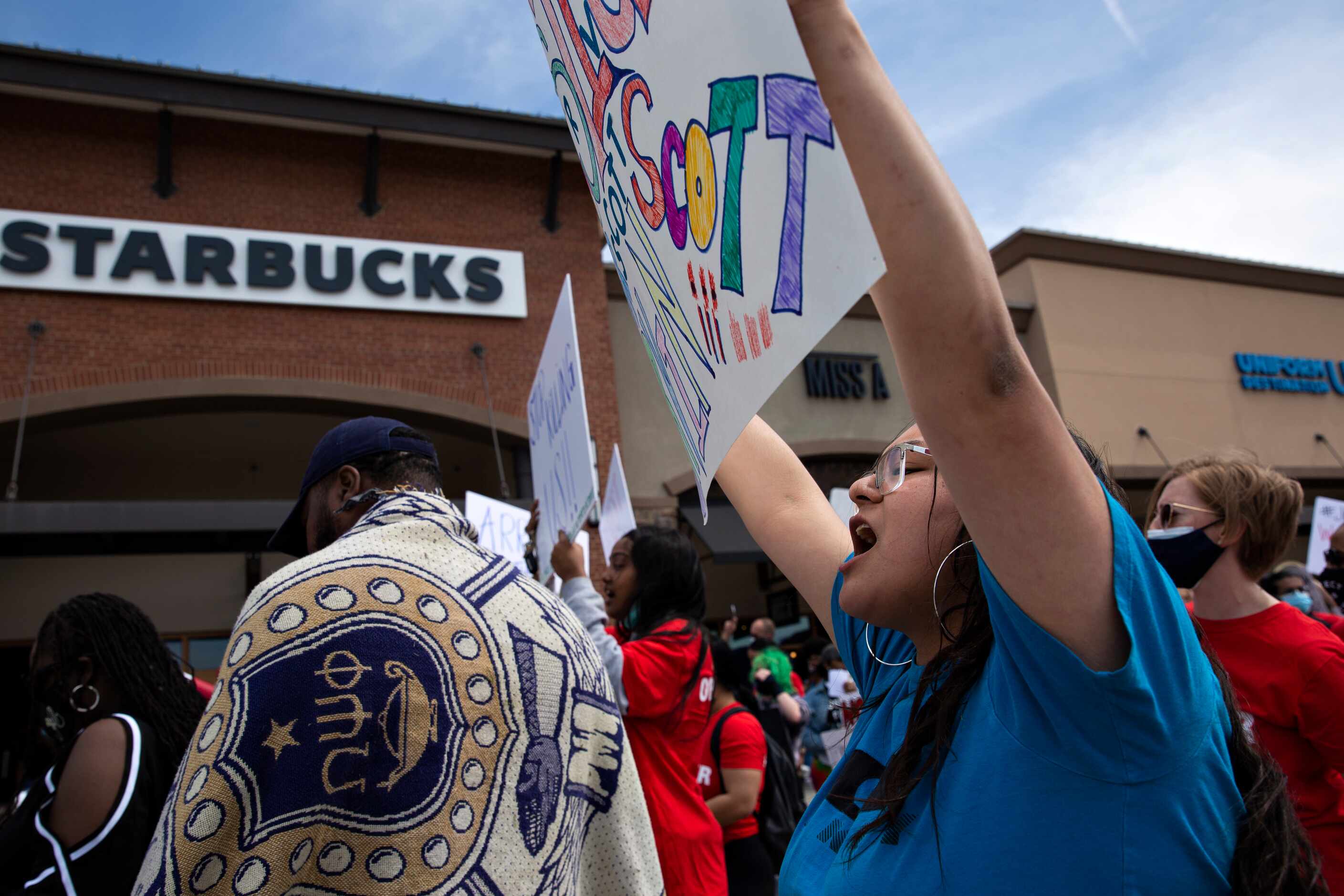Monica Diaz yells the name of one of her best friends, Marvin Scott III, during a march to...
