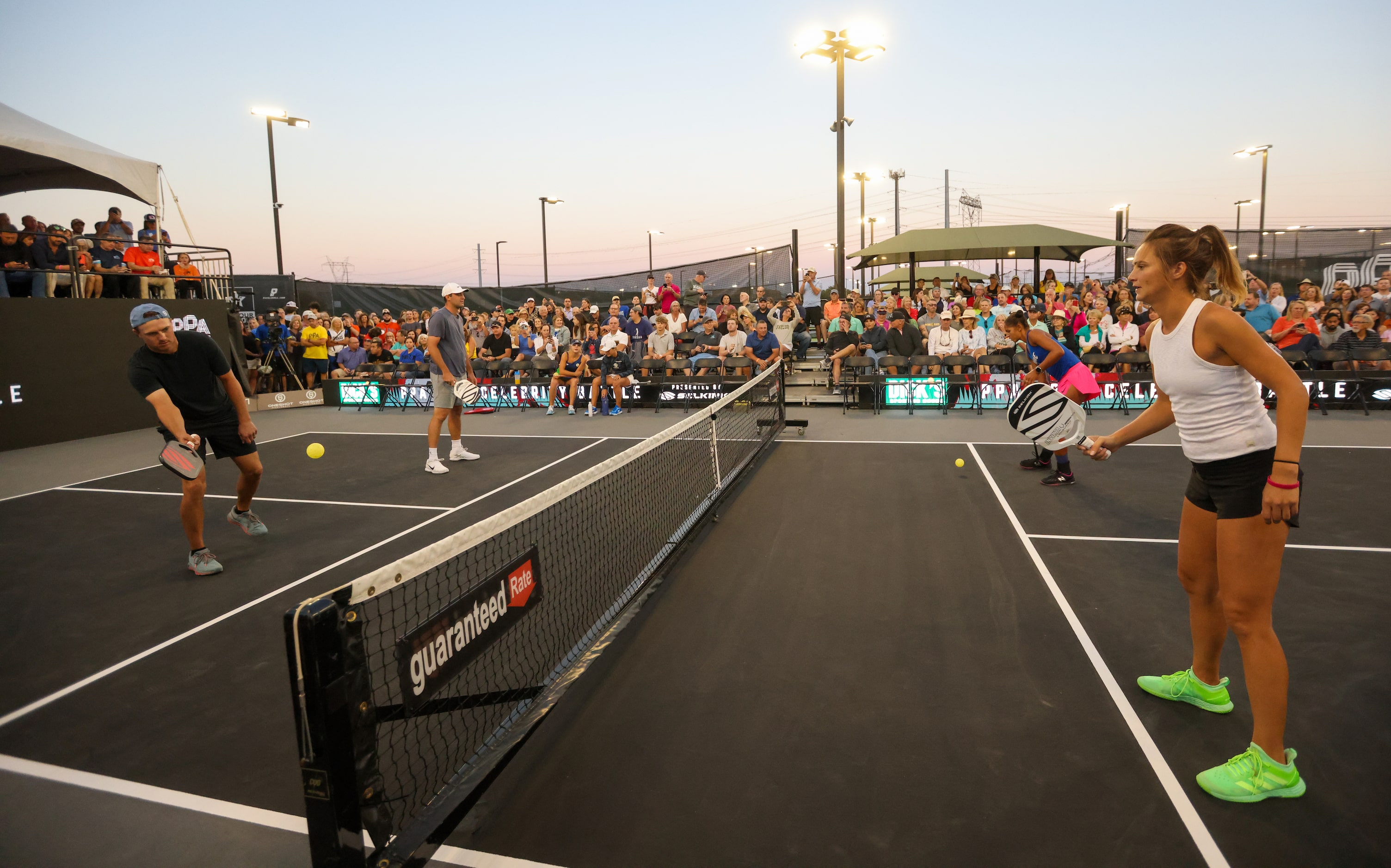 Jordan Spieth (left) warms up with Lea Jansen (right) before playing several doubles matches...