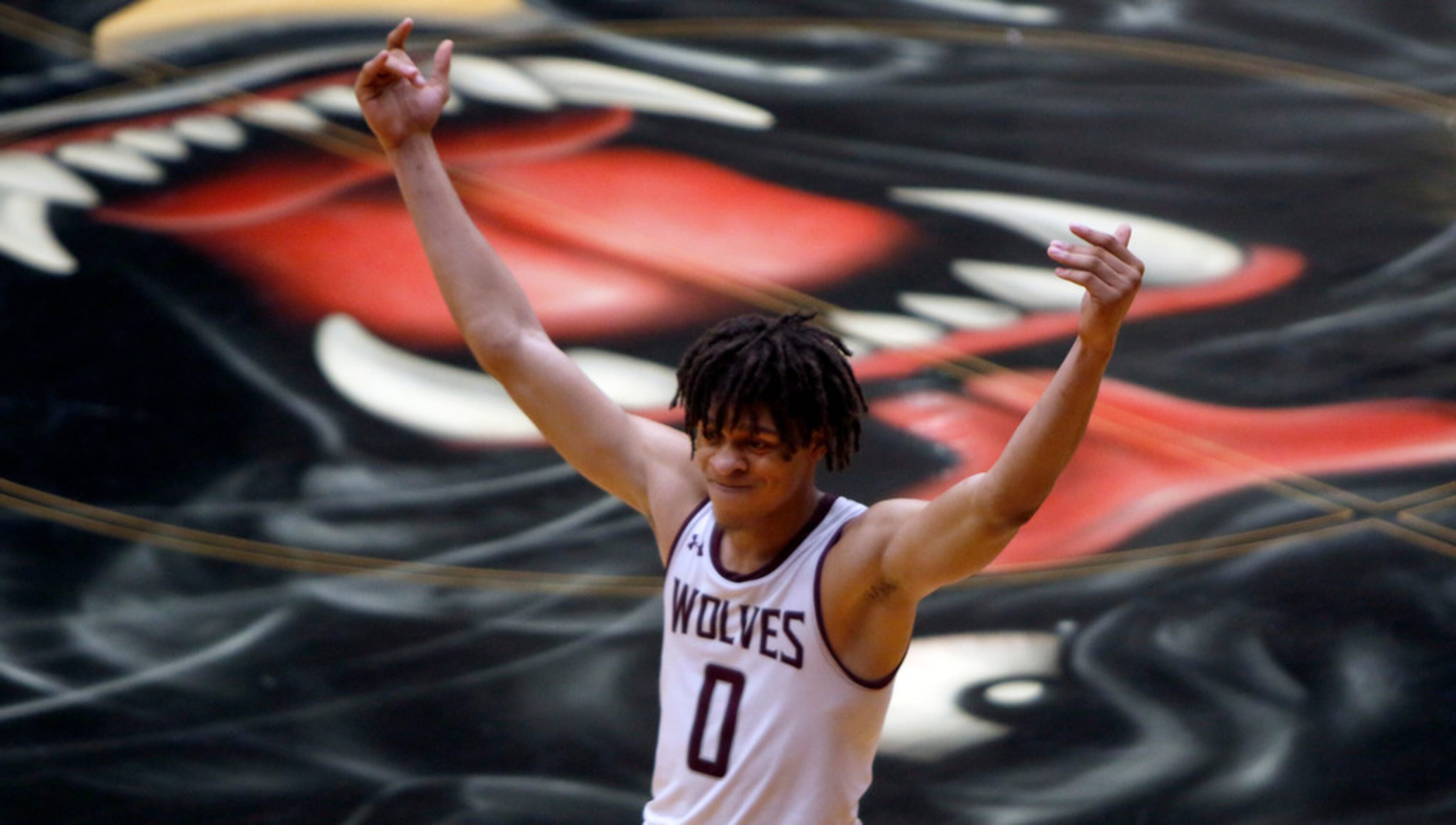 Mansfield Timberview senior Joey Madimba (0) revels in the moment after sinking a shot at...