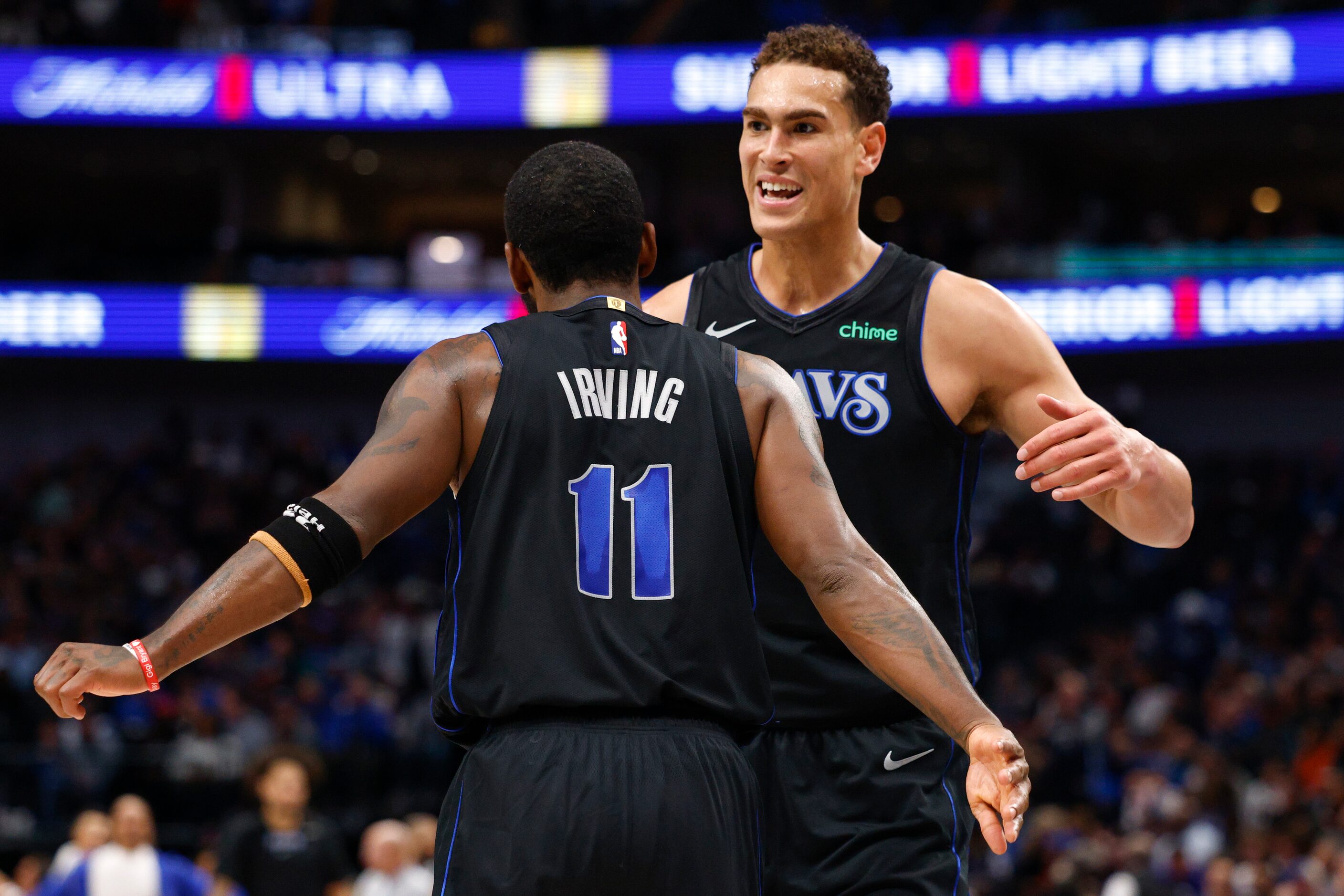 Dallas Mavericks guard Kyrie Irving (11) celebrates with center Dwight Powell (7) during the...