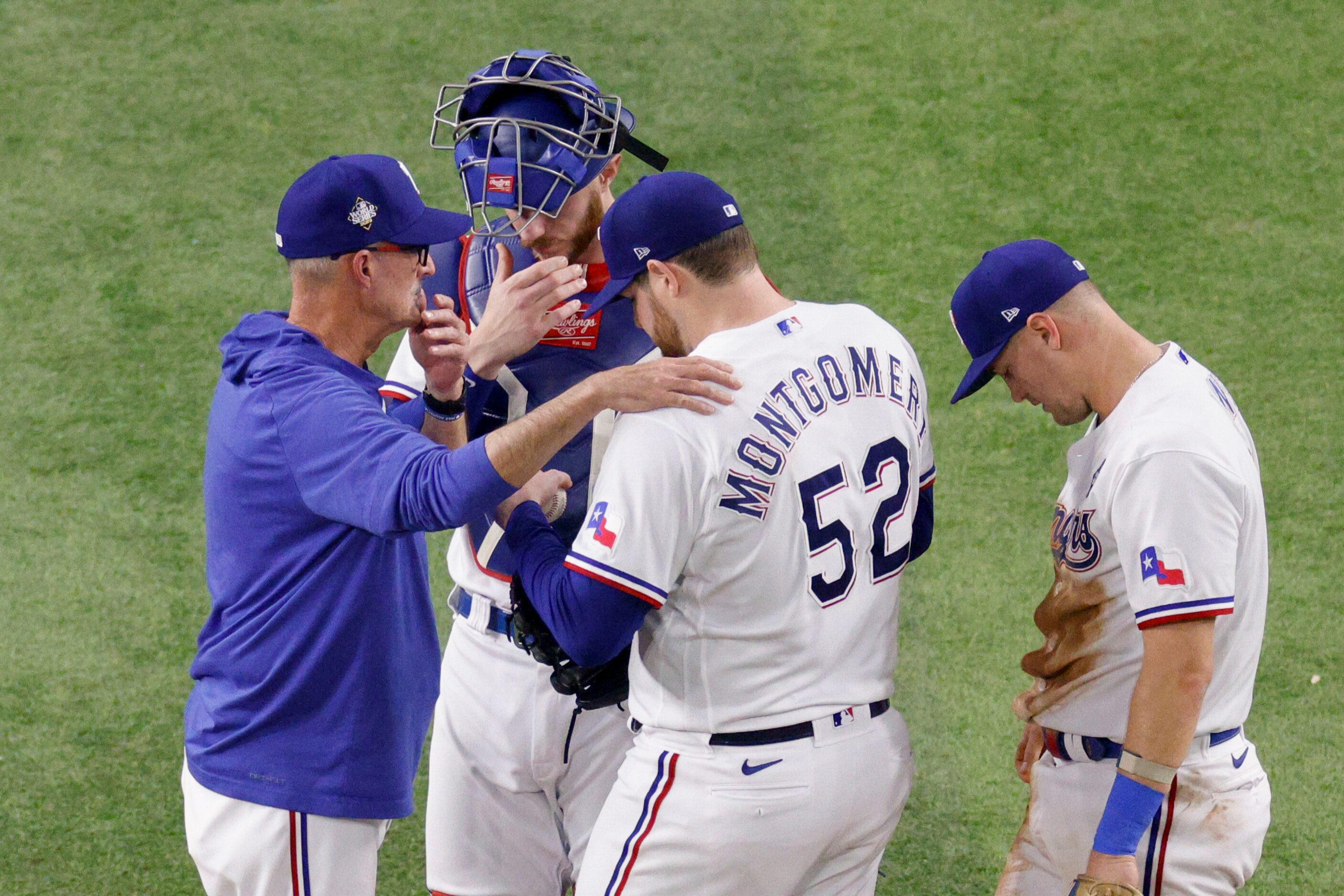 Texas Rangers pitching coach Mike Maddux talks with starting pitcher Jordan Montgomery (52)...