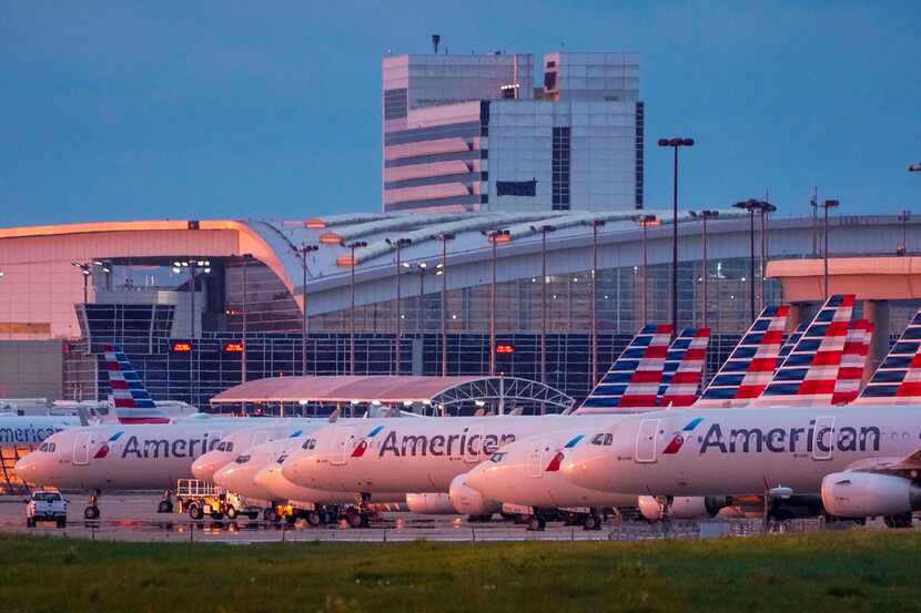 American Airlines aircraft sit parked on the ramp at DFW International Airport on Tuesday,...