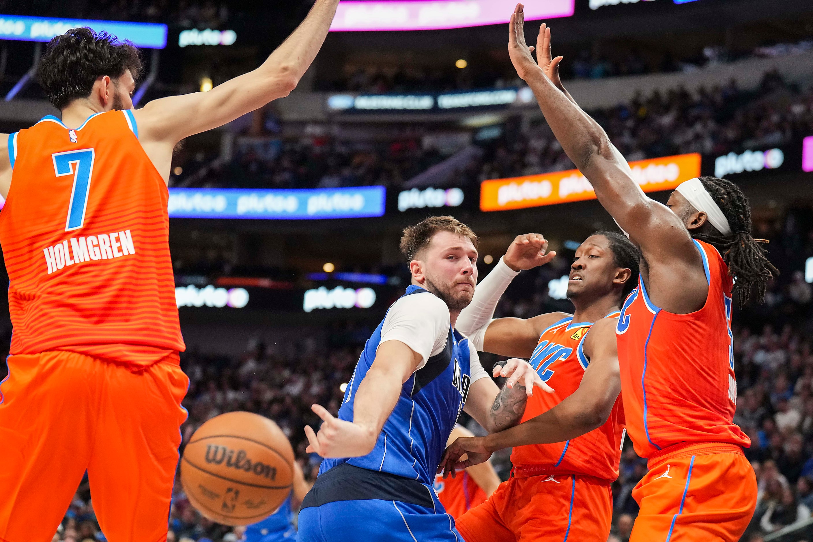 Dallas Mavericks guard Luka Doncic (77) flips a pass behind his back around Oklahoma City...