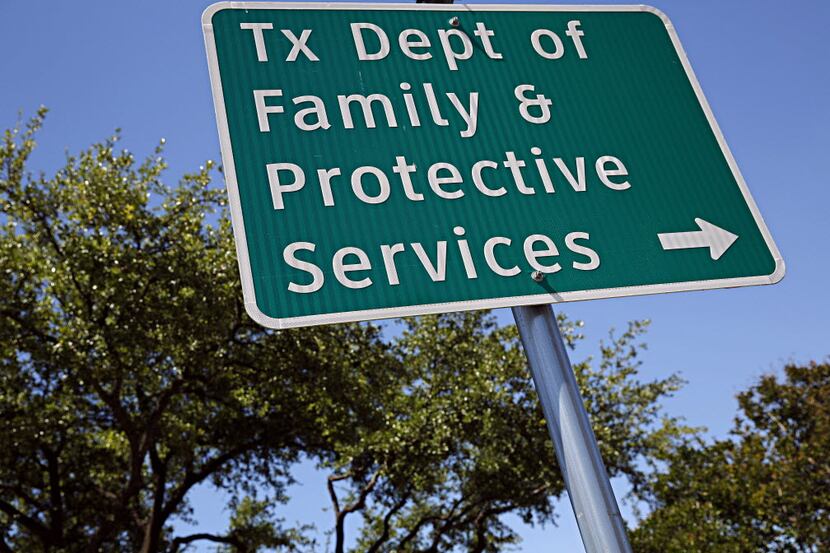 The Texas Department of Family and Protective Services, whose Dallas office sign was...