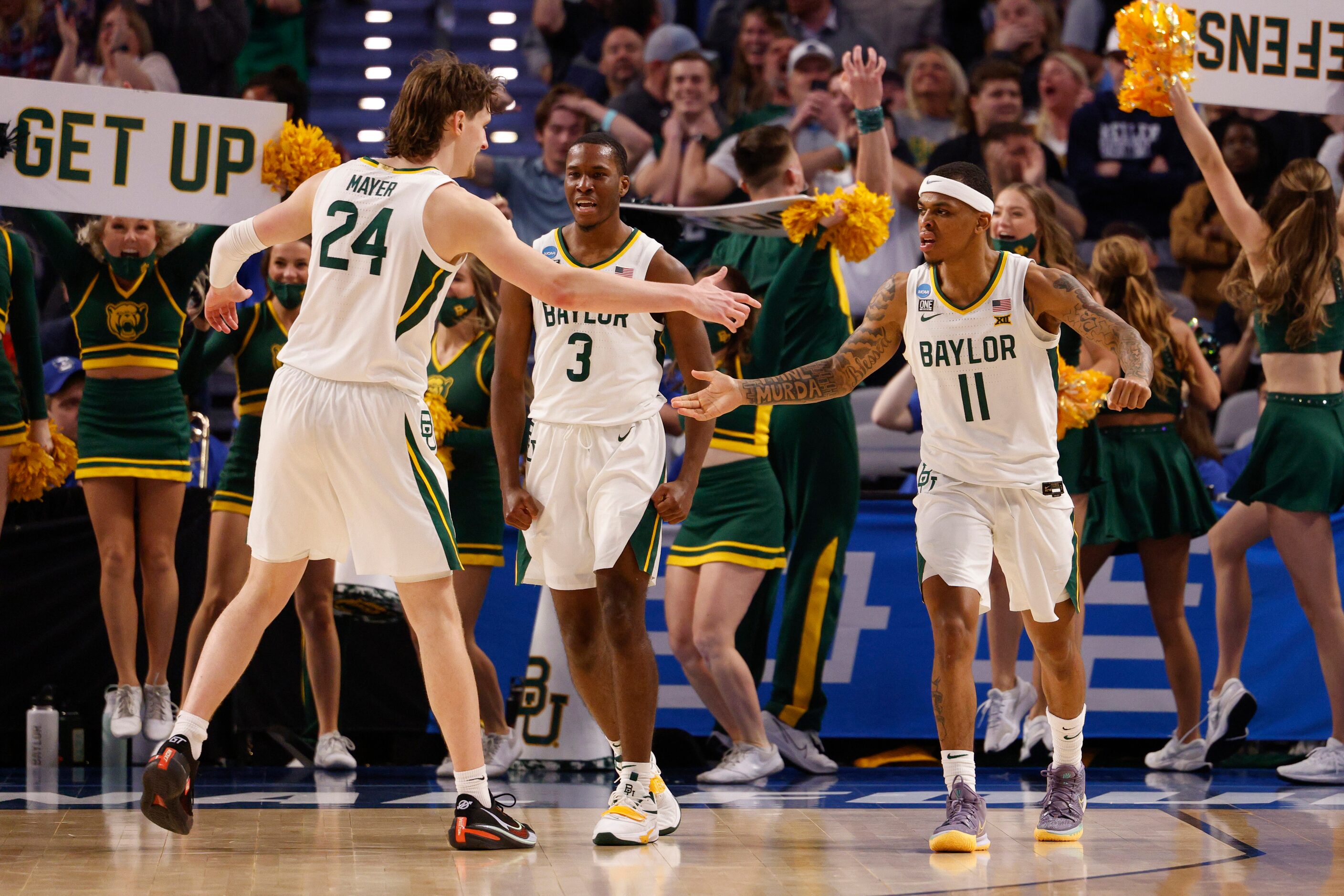 Baylor Bears guard James Akinjo (11) high-fives Baylor Bears guard Matthew Mayer (24) during...