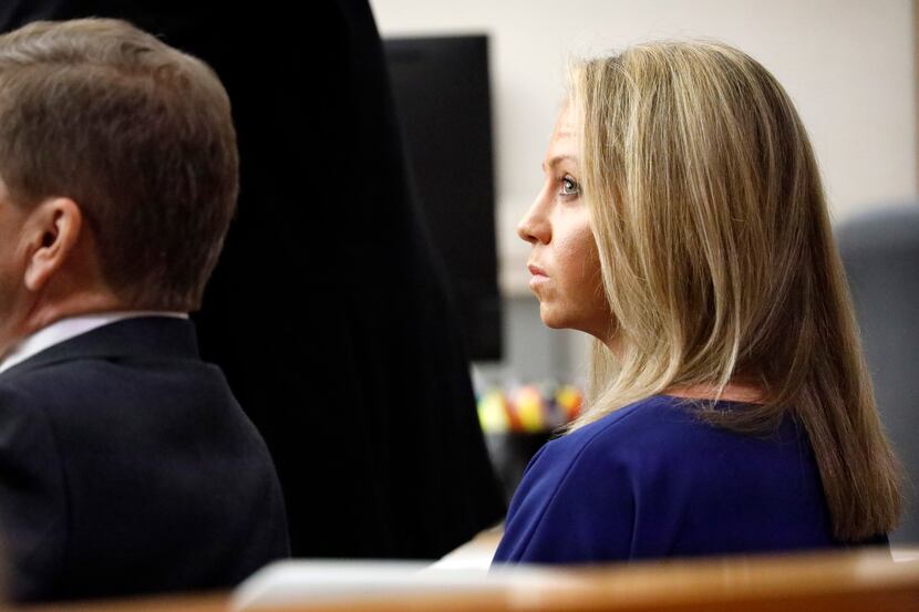 Fired Dallas police Officer Amber Guyger listens to pretrial arguments in Judge Tammy Kemp's...