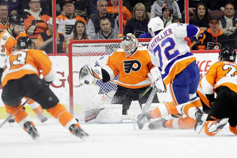 Philadelphia Flyers goalie Steve Mason catches a shot by the New York Islanders' Anthony...