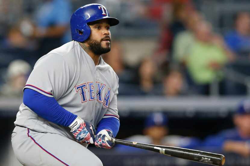 Texas Rangers' Prince Fielder watches his eighth-inning RBI double during a baseball game...