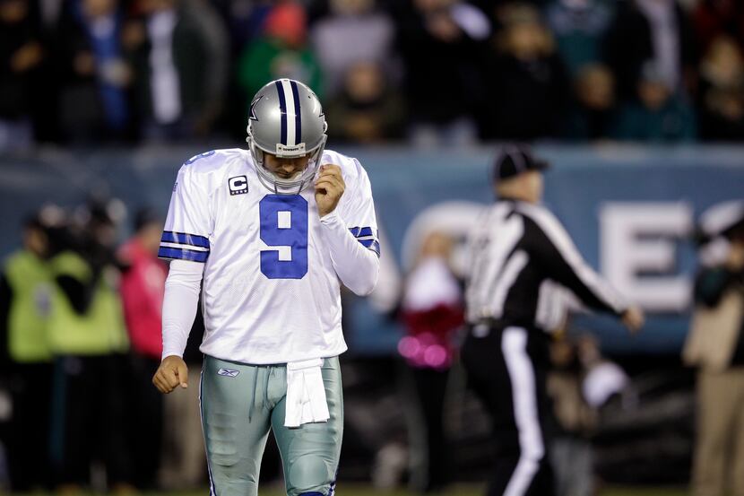 Dallas Cowboys quarterback Tony Romo (9) walks off the field in the first half of an NFL...