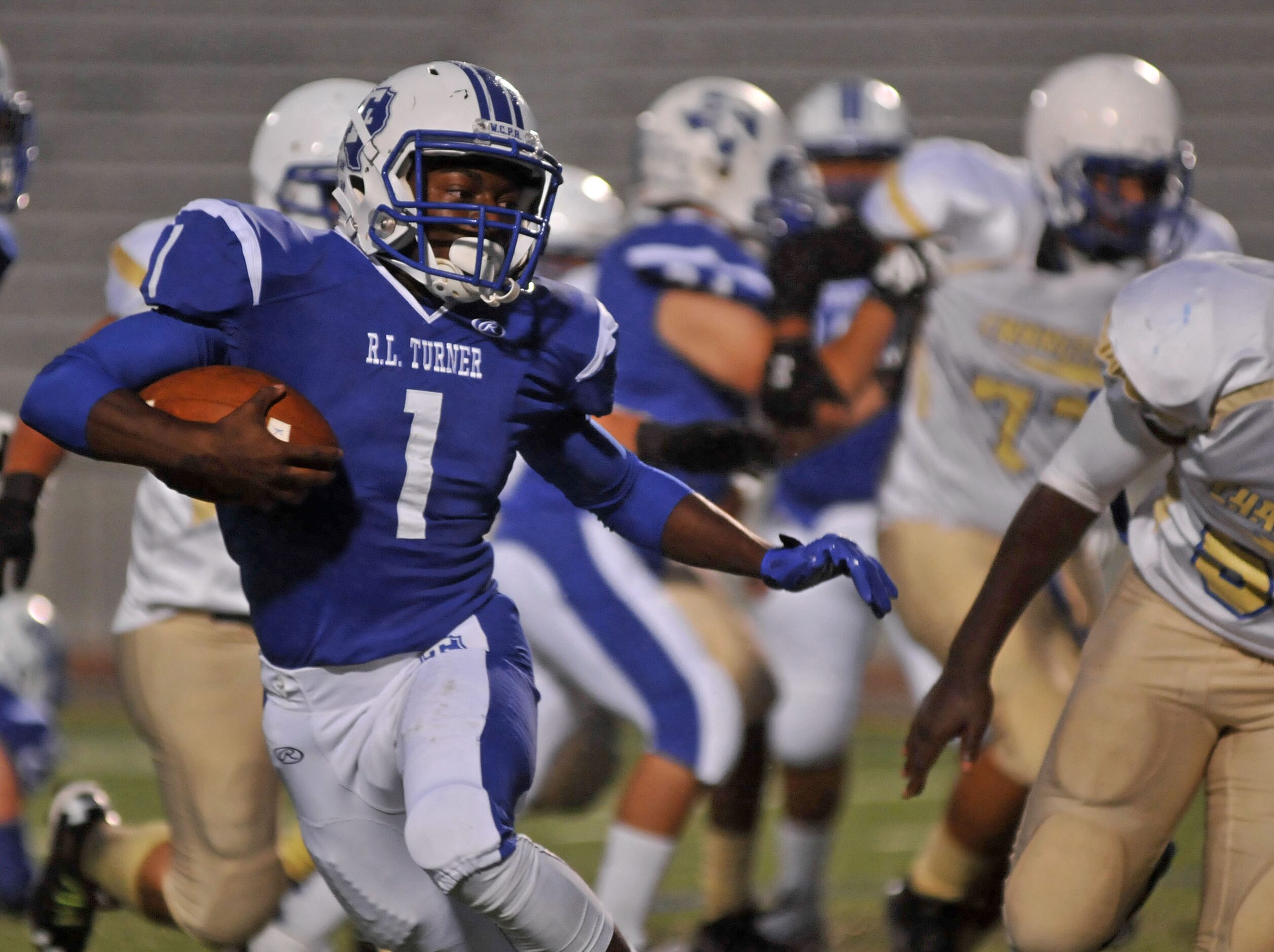 R.L. Turner senior Chris Wolford (1) rushes against Conrad during a high school football...