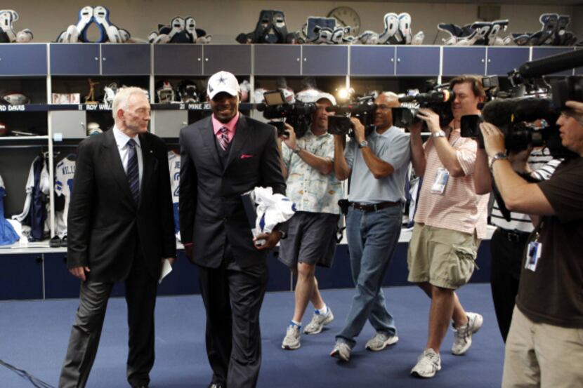 Cowboys owner Jerry Jones and first-round draft pick Dez Bryant walk through the locker room...