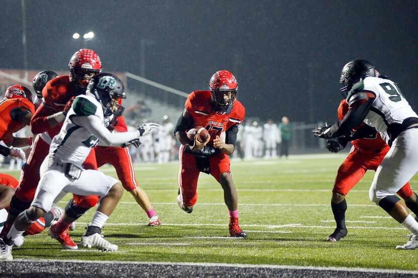 Cedar Hill High quarterback Shayne Lawrence (17) finds a wide open hole to run in a first...