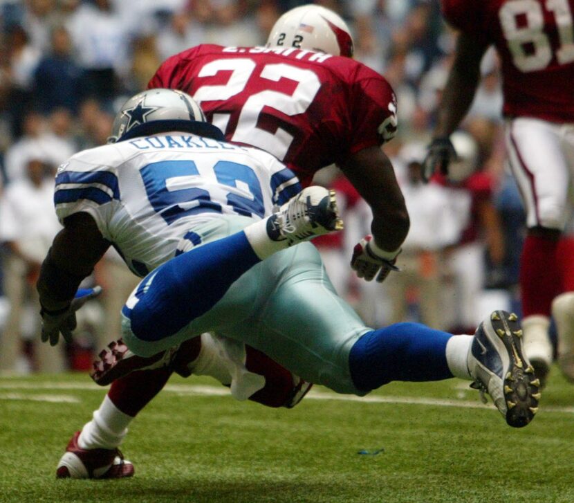 Cowboys vs. Arizona Cardinals at Texas Stadium --   Emmitt Smith is wrapped up by a diving ...