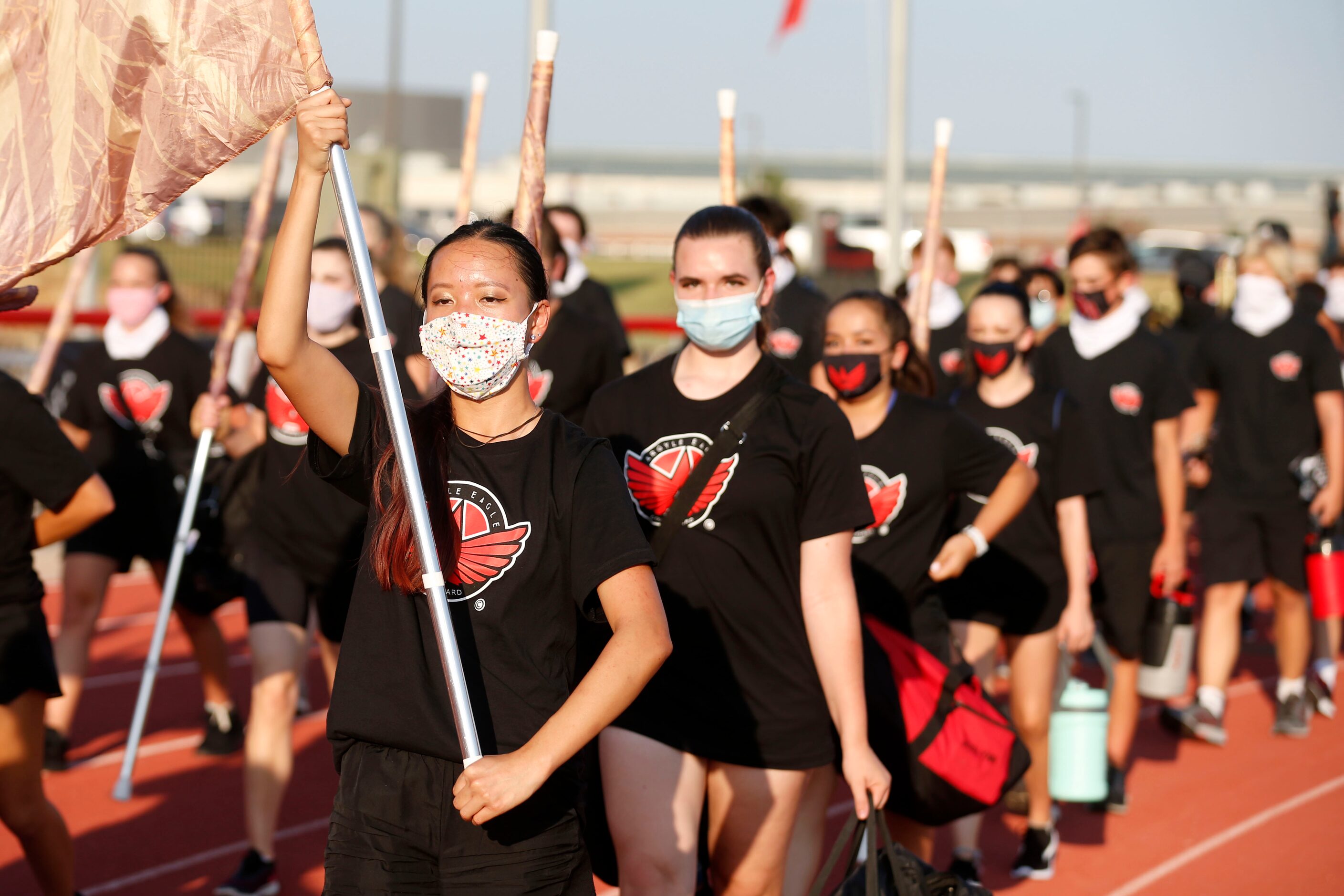 Argyle band member Lily Fillhart, left, marches with the rest of the band prior to a high...