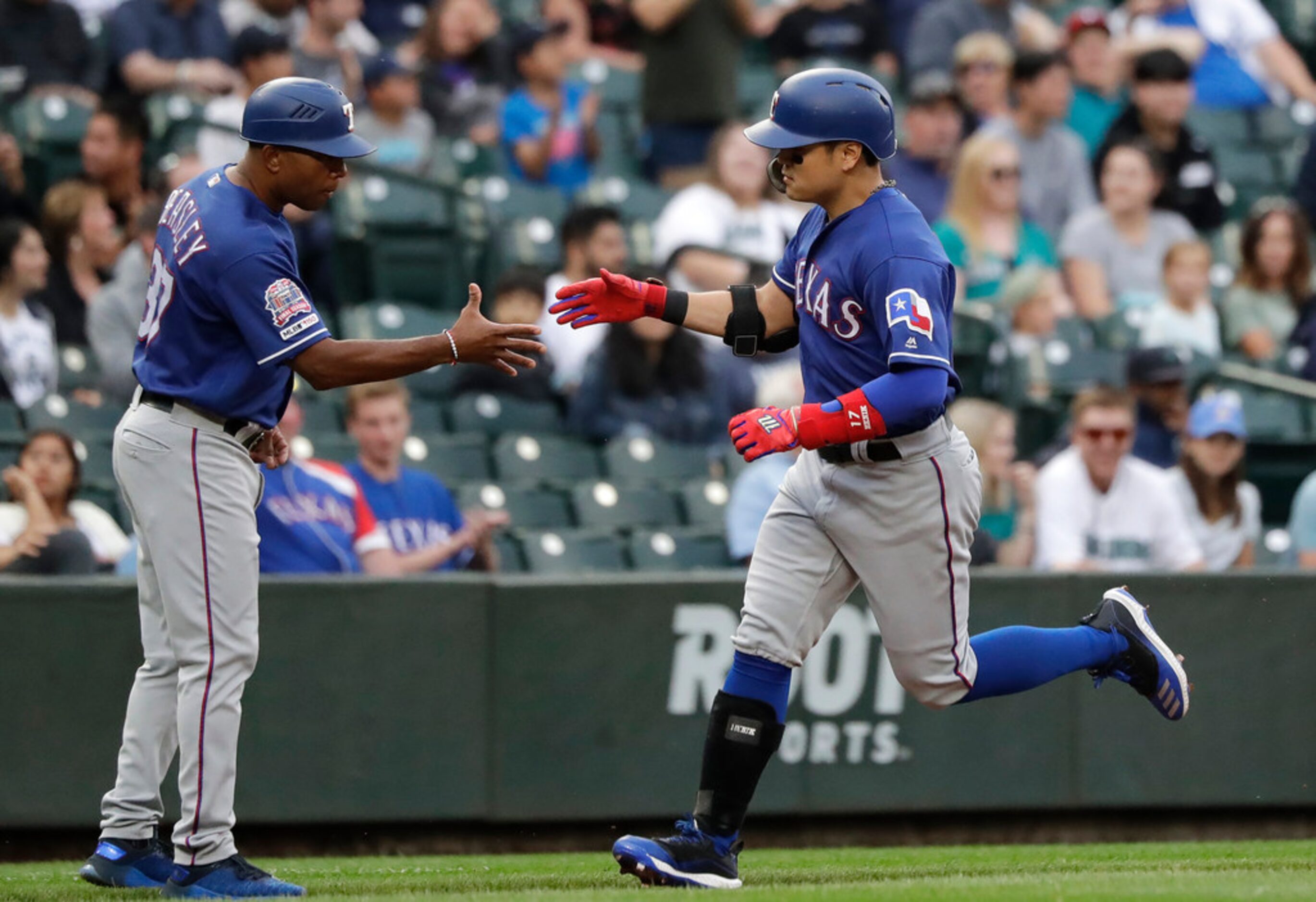 Texas Rangers' Shin-Soo Choo, right, is congratulated on his solo home run against the...