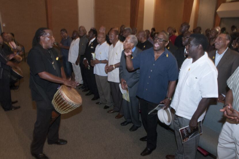 As the Rev. Clarence Glover played the drums, men with pins that read “Real Fathers” sang at...