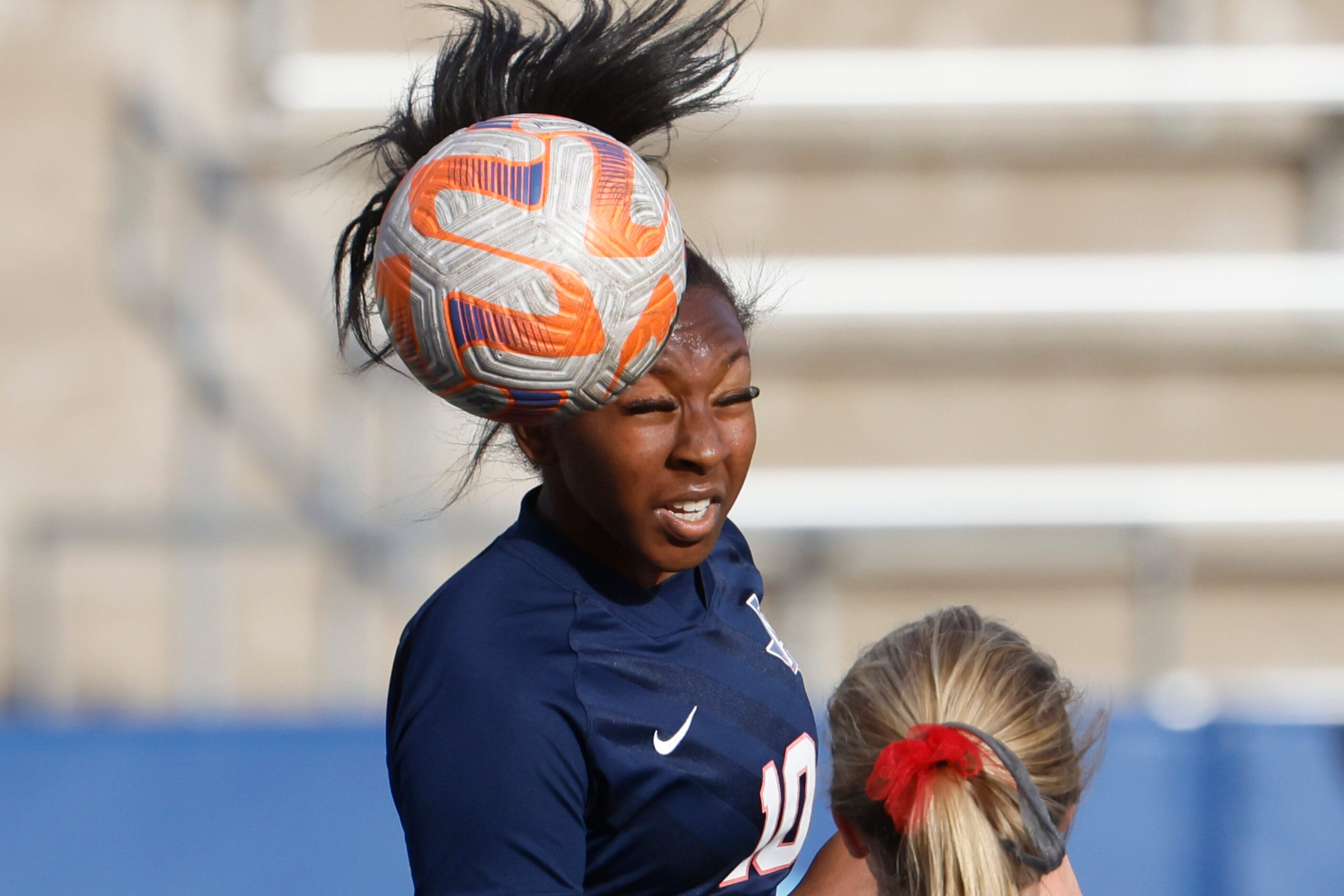 Allen’s Melania Fullerton heads the ball against Marcus during the first half of a regional...