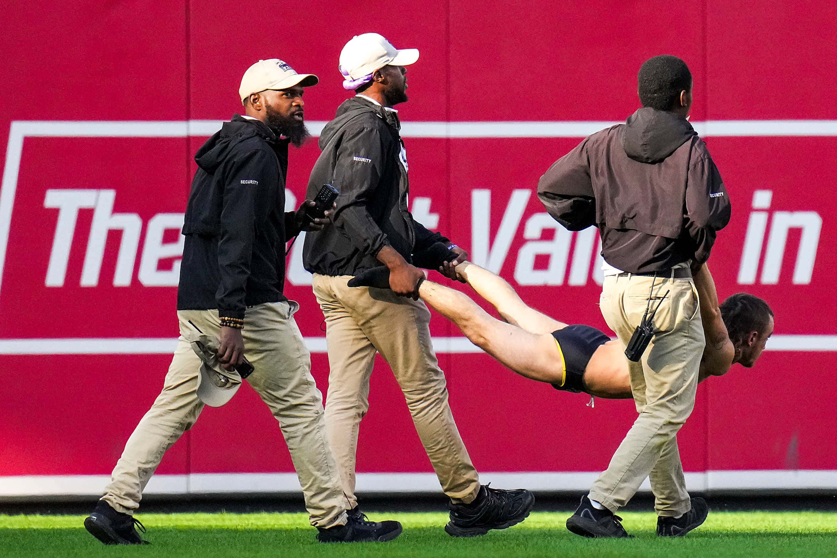 A field intruder is removed from the field during the eighth inning in Game 1 of an American...