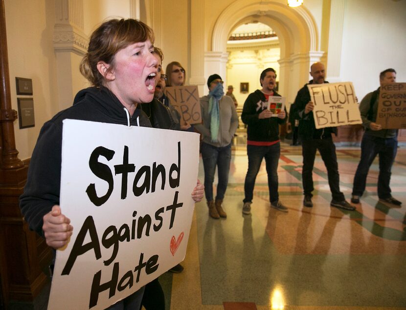 Protesters try to drown out a press conference with Texas Lt. Gov. Dan Patrick and Senator...