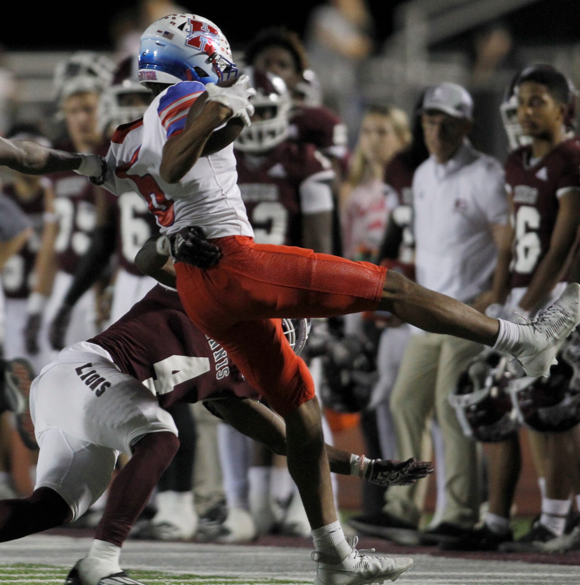 Midlothian Heritage defensive back Freeman Robinson (6), right, is tackled by Ennis running...