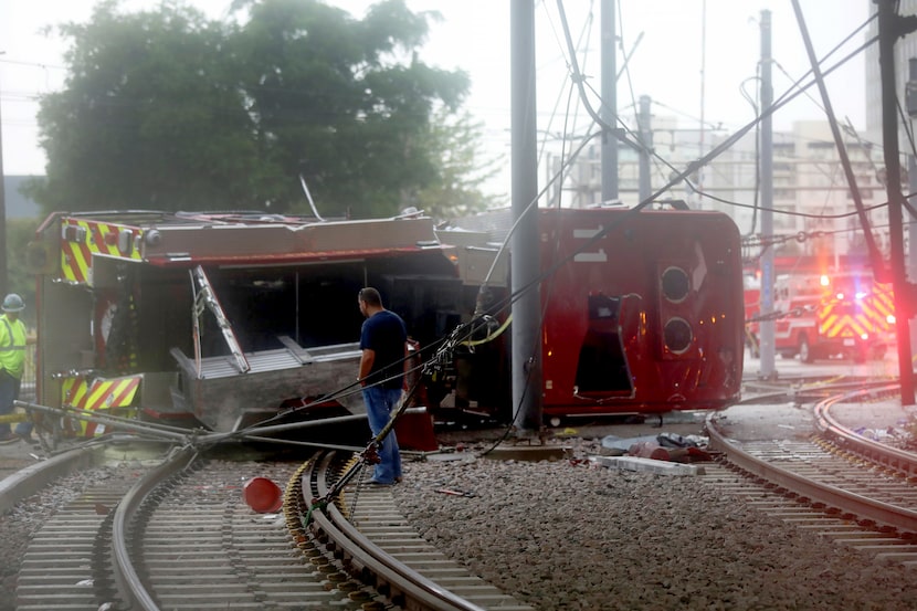 Responders work the scene after a fire truck crashed off an expressway bridge and landed on...