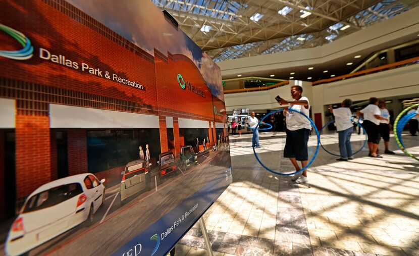 Seniors citizens participated in Chula hooping activity next to a rendering of the new...