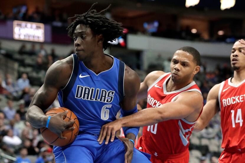 Dallas Mavericks forward Johnathan Motley (6) moves to the basket past Houston Rockets guard...