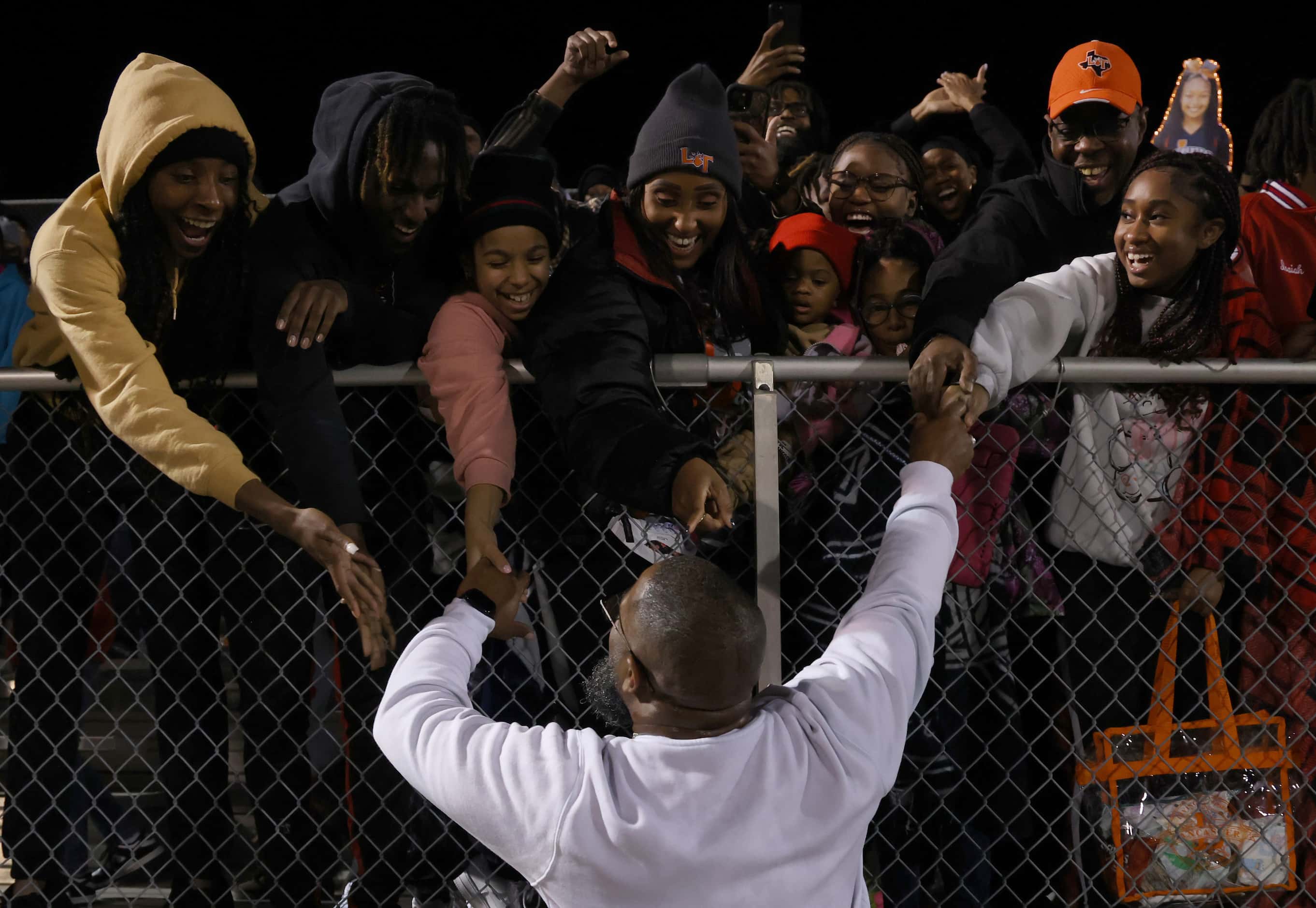 Lancaster head coach Leon Paul goes to greet Tigers fans in the stands following their 27-24...