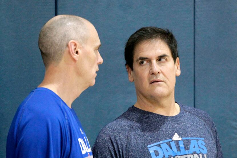 Dallas Mavericks head coach Rick Carlisle talks with owner Mark Cuban near the end of...