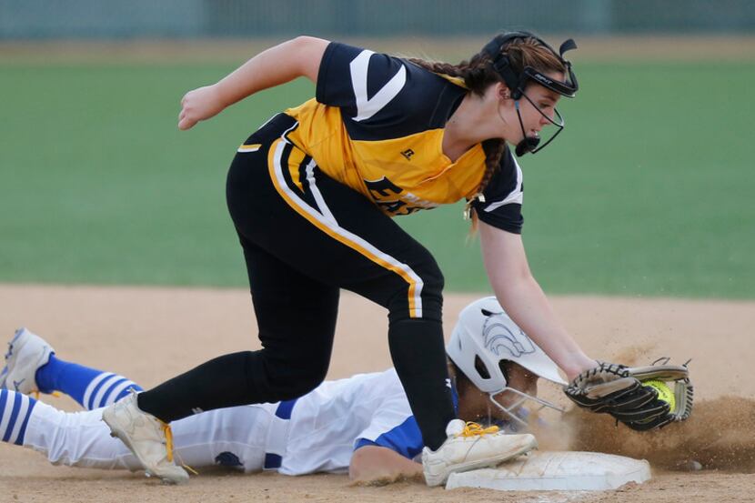 Plano West's Micayla Clark (9) is safe on pickoff attempt at first base as Plano East's...
