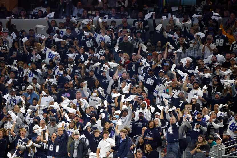 Dallas Cowboys fans cheer during the second half of an NFL football game against the Arizona...