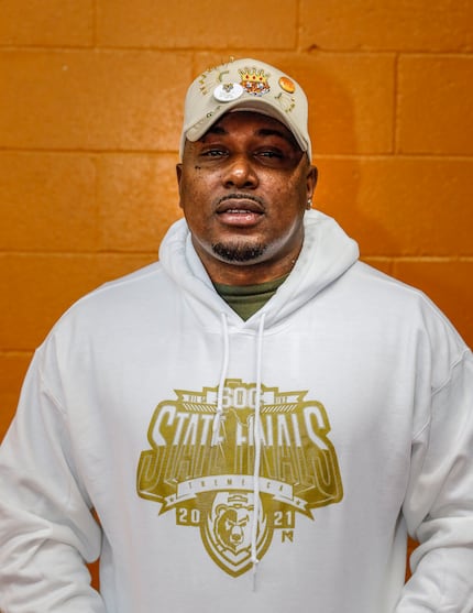 Cedrick Miles, co-owner of Fade Row, wears a State Finals sweatshirt at his barbershop in...