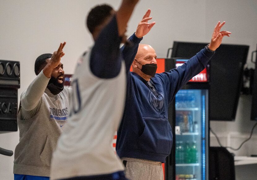 Dallas Mavericks head coach Jason Kidd, right, cheers on the sidelines during the first...