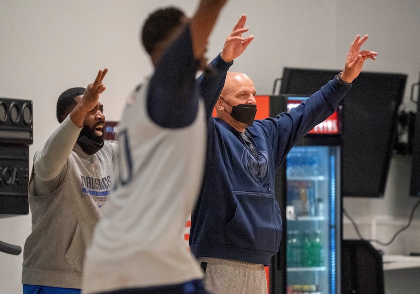 Dallas Mavericks head coach Jason Kidd, right, cheers on the sidelines during the first...