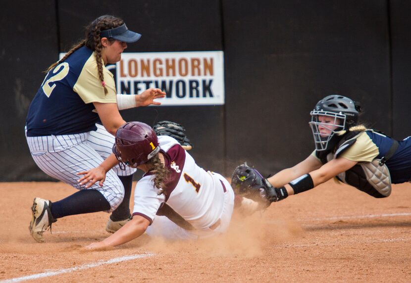 Deer Park's Sara Vanderford (1) slides into home as Keller pitcher Dylann Kaderka (22) and...