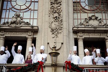 Cooks from The Adolphus hotel wave during the Dallas Children's Health Holiday Parade in...