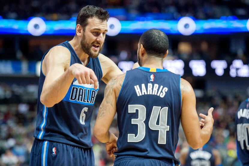 Dallas Mavericks center Andrew Bogut (6) talks with guard Devin Harris (34) during a timeout...