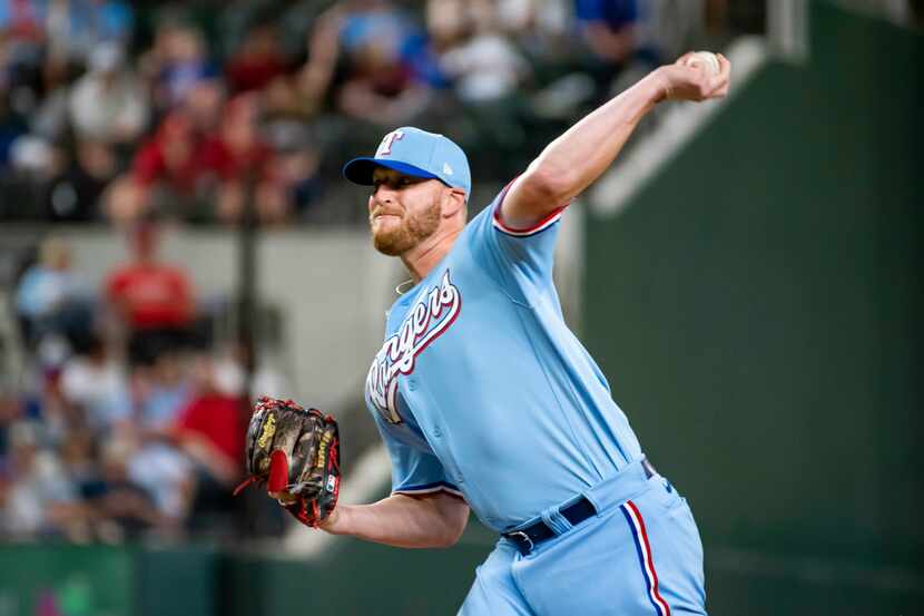 Texas Rangers relief pitcher Will Smith delivers in the top of the ninth inning in a...